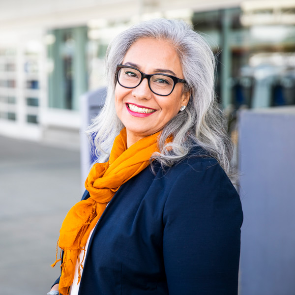 mature woman with yellow scarf and glasses