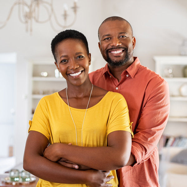 couple in colorful shirts smiling