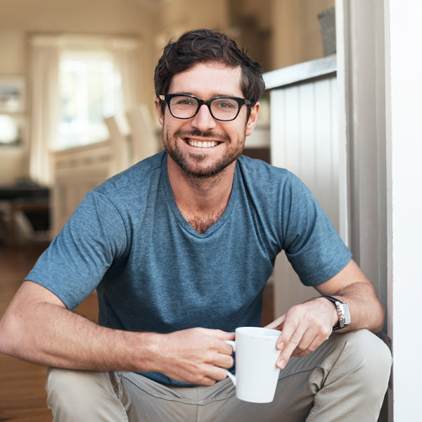 man in glasses and blue shirt smiling