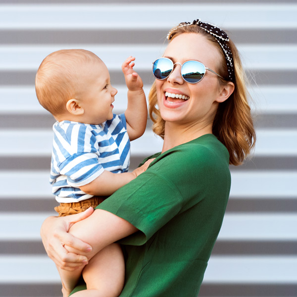 young mom and baby smiling