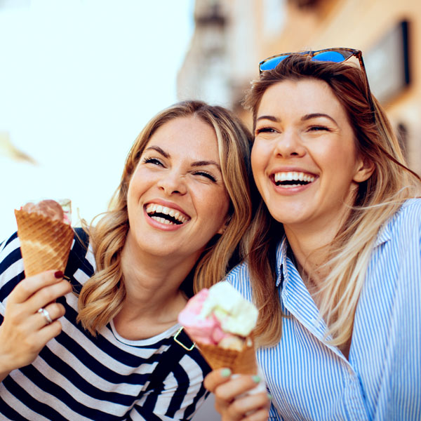 sisters laughing and enjoying ice cream