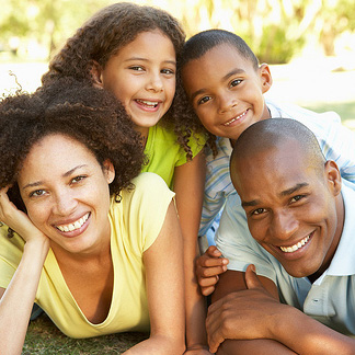 young family outdoors smiling