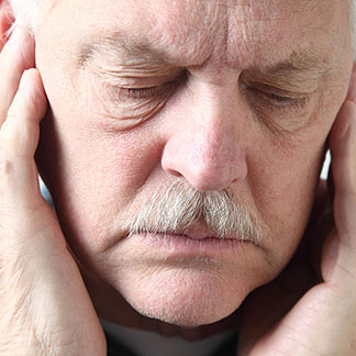 old man holding his face in pain