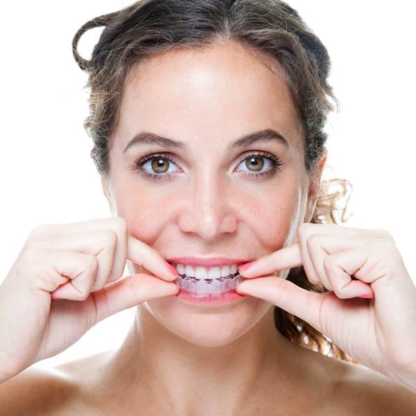 woman with clear aligners